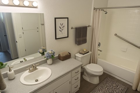 A bathroom with a white sink and toilet.