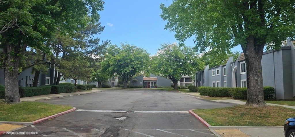A tree-lined street with a car parked on the side.