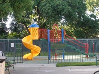 a childrens playground with a large yellow slide