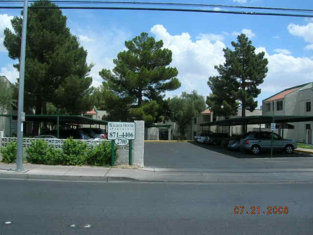a street view of a parking lot with cars and buildings