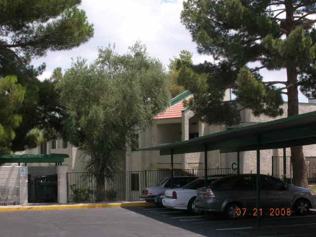 a building with cars parked in a parking lot