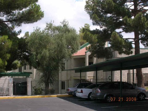 a building with cars parked in a parking lot