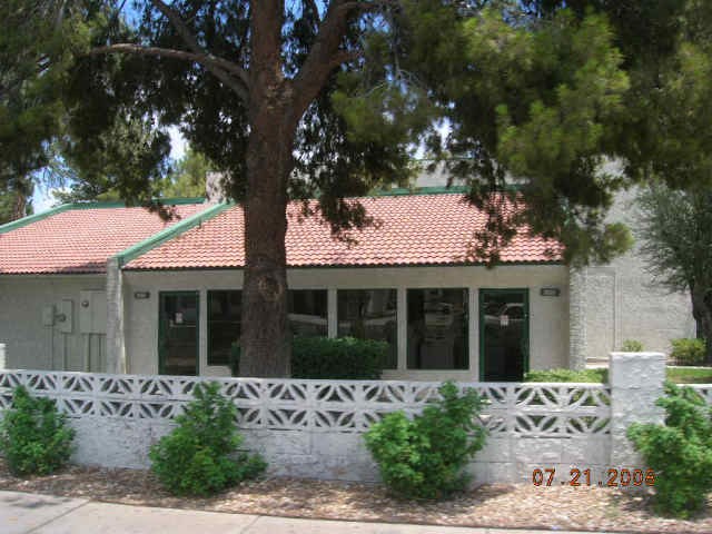 a white house with a tree in front of it