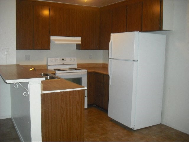 a kitchen with a stove and a refrigerator