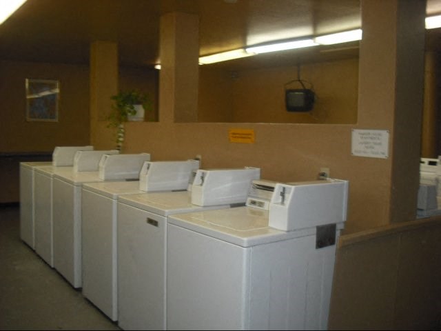 a row of white washing machines in a room