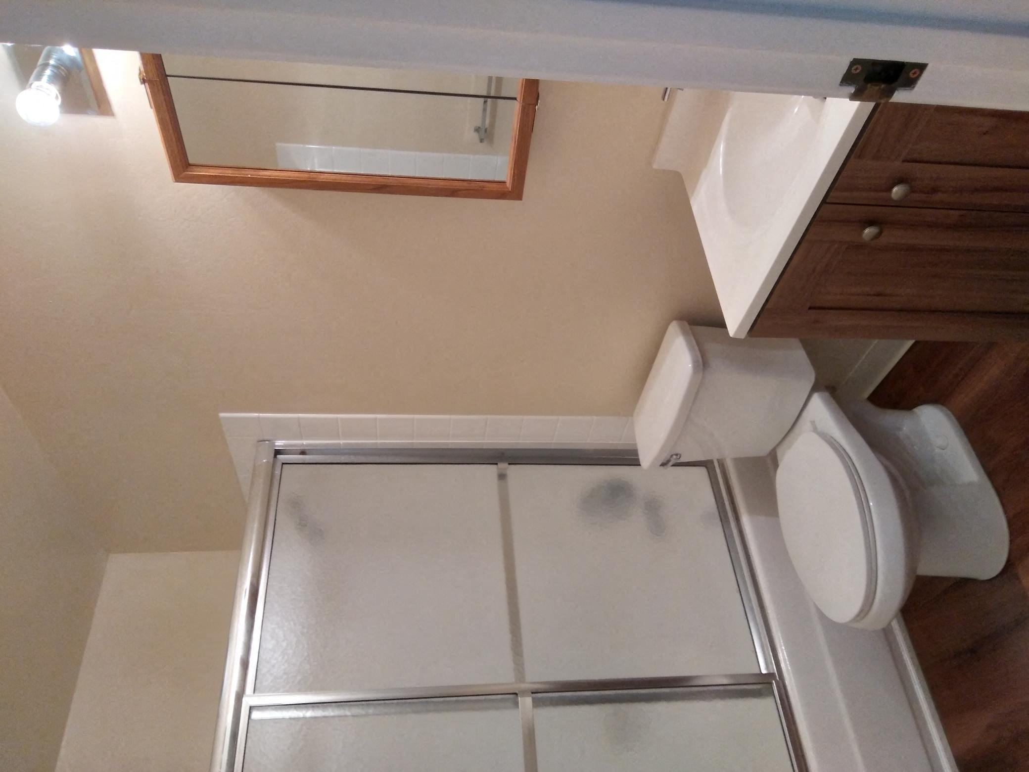 a small bathroom with a toilet and a shower