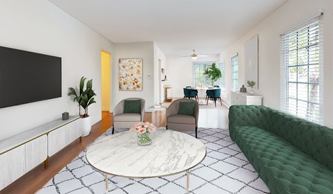A living room with a green sofa and a white coffee table.