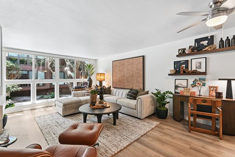 A living room with a brown leather chair and a white couch.