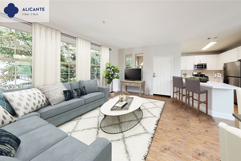 A living room with a grey sofa and a coffee table in the middle.
