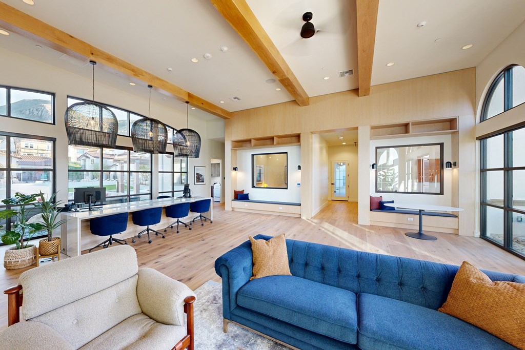 A blue couch with a white cushion is in the middle of a room with a wooden floor at The Villas at Anacapa Canyon, Camarillo, 93012