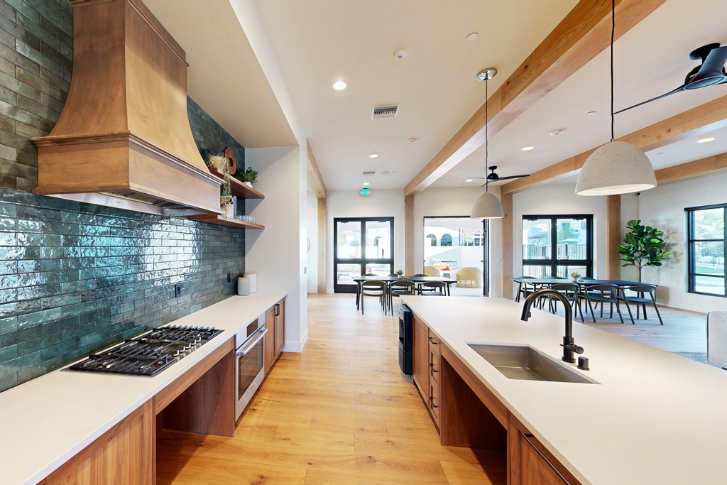 A modern kitchen with wooden cabinets and a green backsplash at The Villas at Anacapa Canyon, Camarillo, 93012