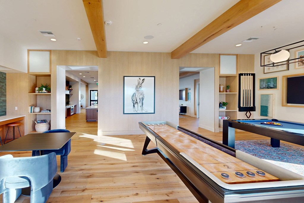 A room with a pool table and a picture of a rabbit on the wall at The Villas at Anacapa Canyon, Camarillo, 93012