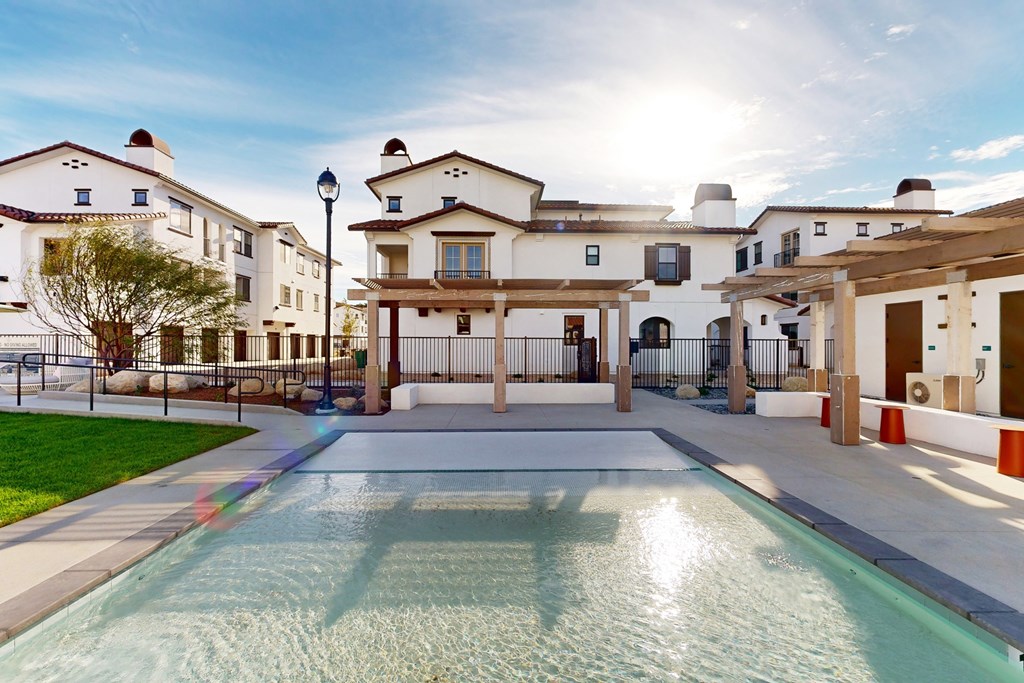 A swimming pool in front of a building with a sunny sky at The Villas at Anacapa Canyon, Camarillo, 93012