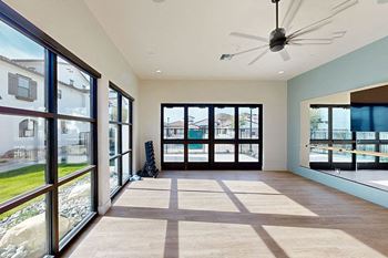 a living room with large windows and a ceiling fan at The Villas at Anacapa Canyon, Camarillo, CA, 93012