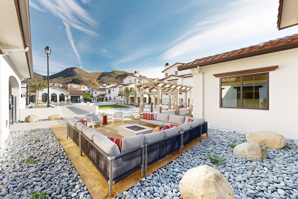 A patio with a couch and a table with a mountain in the background at The Villas at Anacapa Canyon, Camarillo, 93012
