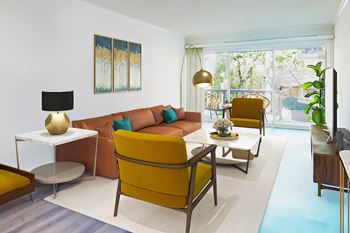A living room with a yellow chair and a white table at Casa Granada, California, 90049