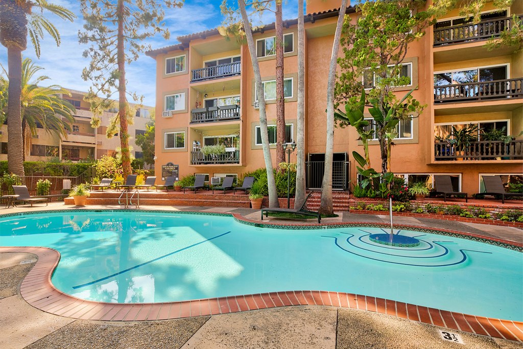 A large swimming pool in front of a multi-story apartment building at Casa Granada, Los Angeles, 90049