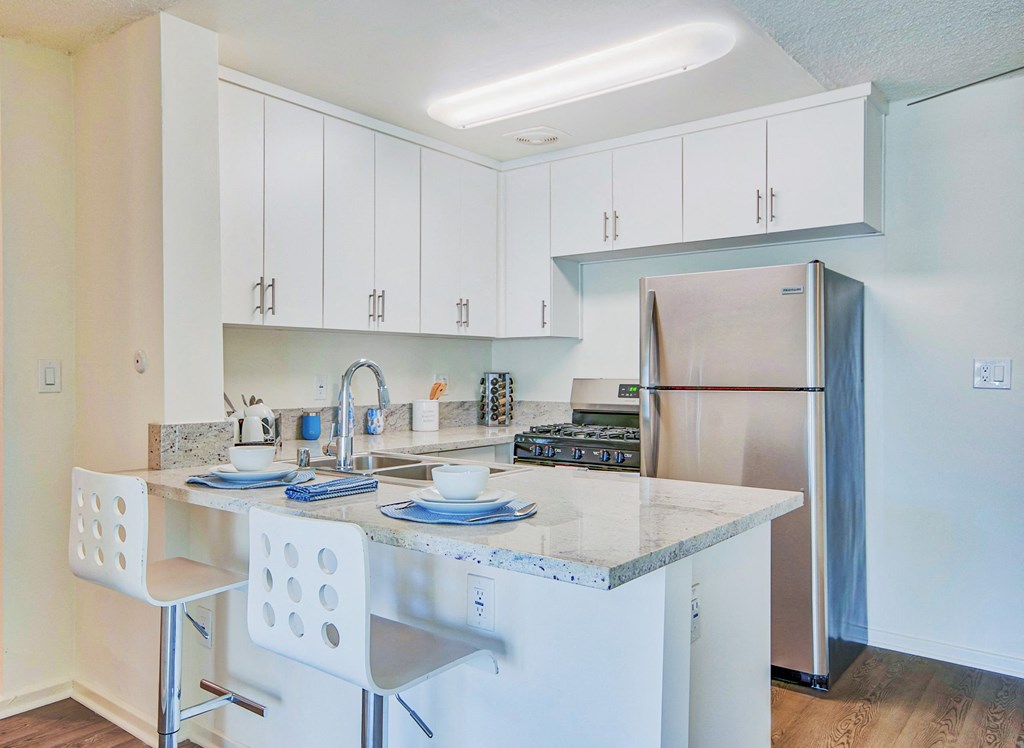 a kitchen with an island and stainless steel refrigerator at Villa Vicente, California