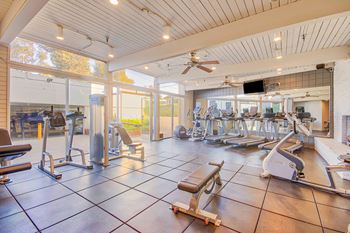 a gym with a lot of weights and cardio equipment at Villa Vicente, Los Angeles, CA, 90019