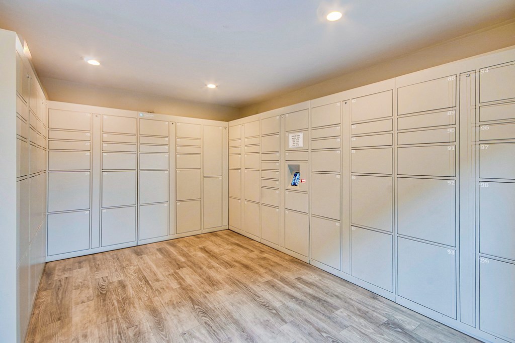 a large walk in closet with white cabinets and a wood floor at Villa Vicente, Los Angeles, CA