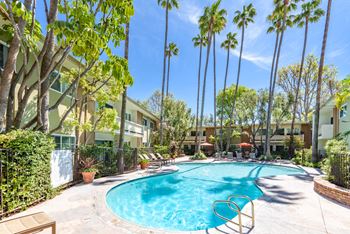 a swimming pool with palm trees and a resort style pool at Villa Vicente, Los Angeles, CA