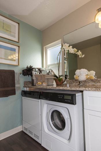a washer and dryer in a bathroom with a counter top and a sink at Valley Plaza Villages, Pleasanton, 94566