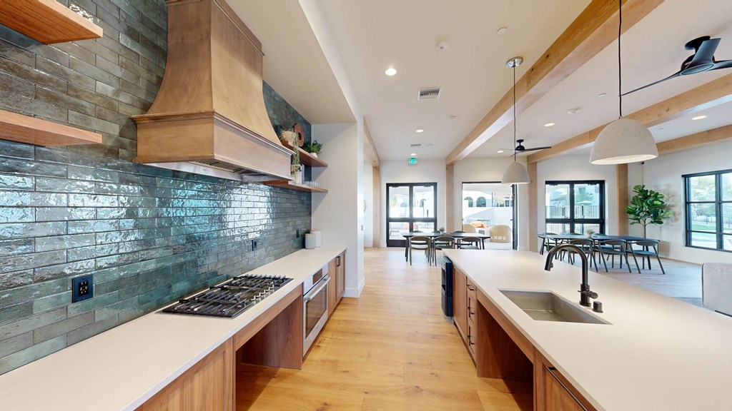 a large kitchen with a long counter top and a sink at The Villas at Anacapa Canyon, Camarillo, CA, 93012