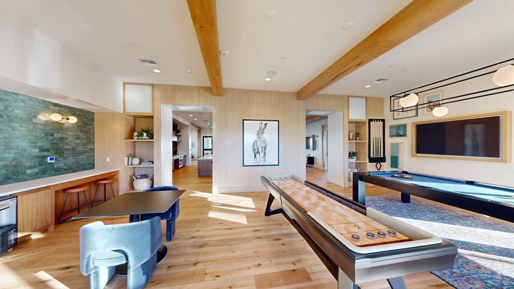 a games room with a pool table and a television at The Villas at Anacapa Canyon, Camarillo, CA