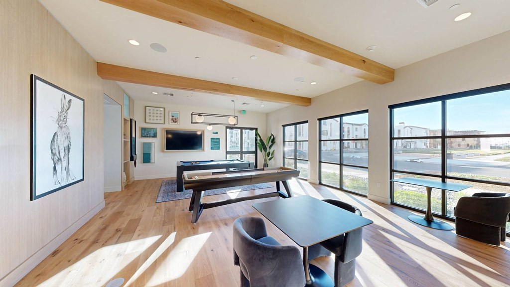 a living room with a table and chairs and large windows at The Villas at Anacapa Canyon, Camarillo