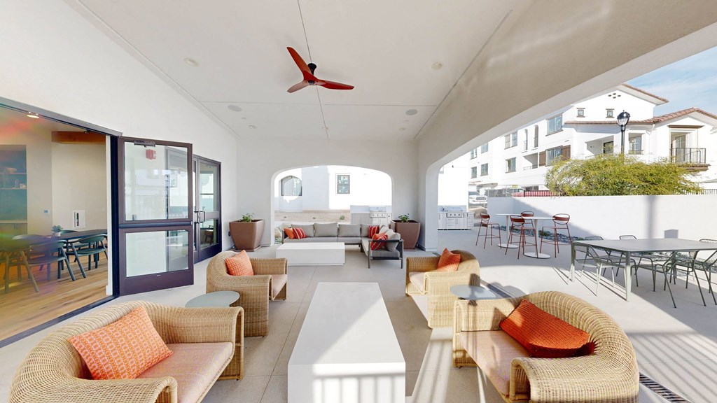 a living room with couches and chairs and a patio at The Villas at Anacapa Canyon, Camarillo, California