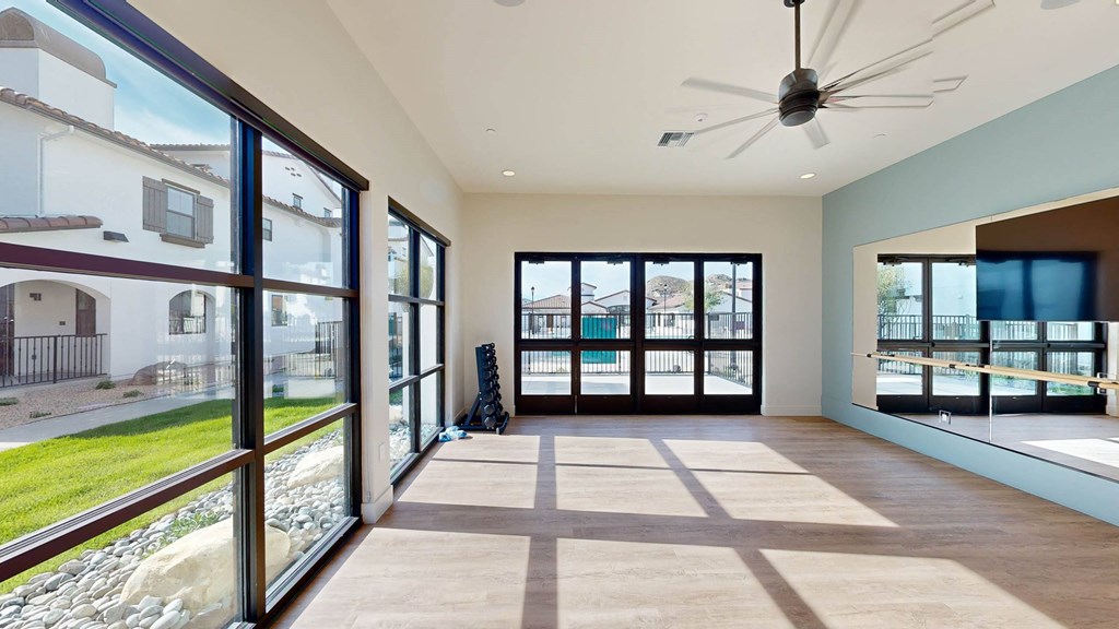 a living room with large windows and a ceiling fan at The Villas at Anacapa Canyon, California
