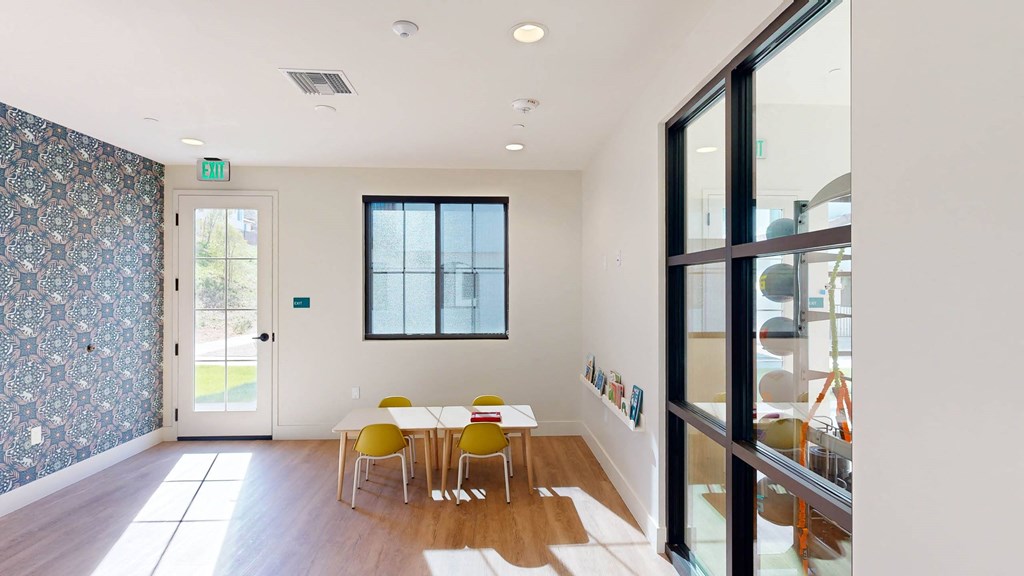 a dining room with a table and chairs and a glass door at The Villas at Anacapa Canyon, Camarillo, CA, 93012