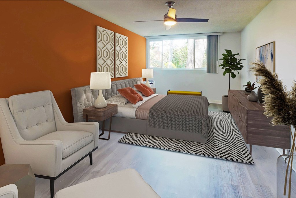 a bedroom with an orange accent wall and a bed a bedroom with an orange accent wall and a bed at Casa Granada, Los Angeles, 90049