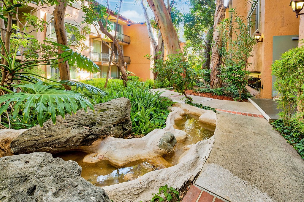a small waterfall in the middle of a courtyard  at Casa Granada, Los Angeles, CA