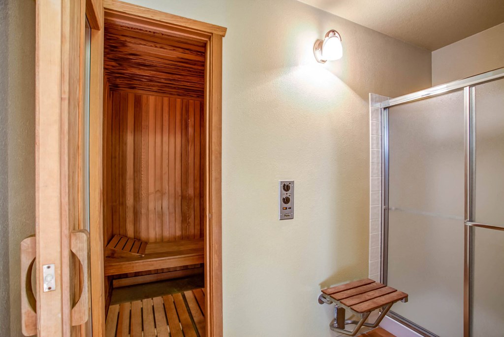 a sauna room with a shower and a wooden bench at Valley Plaza Villages, California, 94566