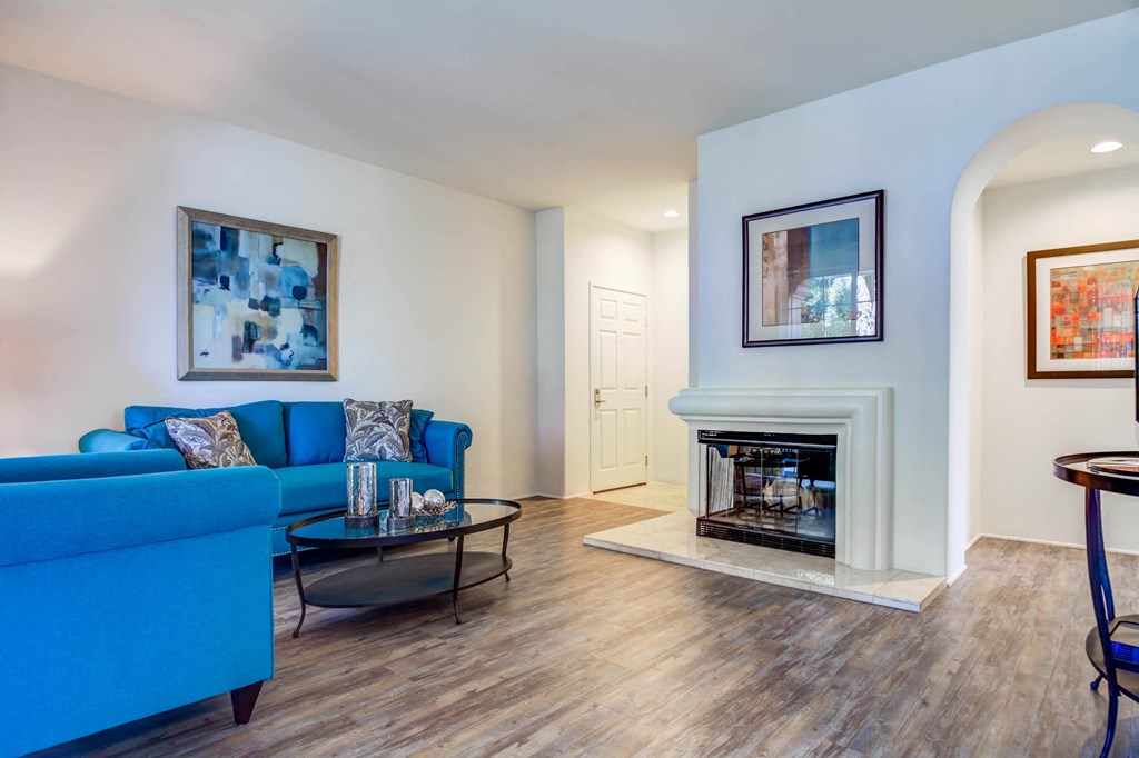 Living room featuring a fireplace at L'Estancia Apartment Homes
