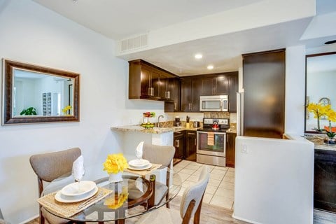 Kitchen and dining area at L'Estancia Apartment Homes