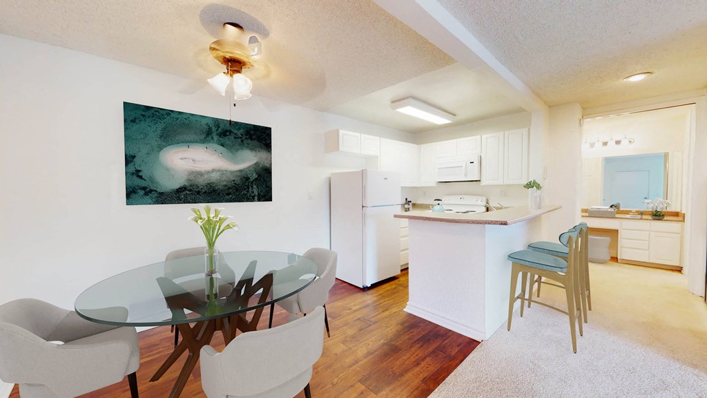 a dining room and kitchen with a glass table and chairs a dining room and kitchen with a glass table and chairs at Mariners Village, Marina del Rey, 90292