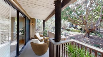 a porch with two chairs and a tree at Mariners Village, Marina del Rey, 90292