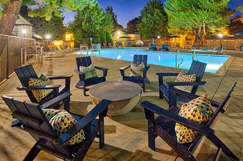 a swimming pool at night with chairs and a table at Mountain Vista, Victorville, CA, 92395