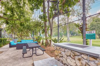 a patio with a table and chairs and a fire pit  at Rancho Los Feliz, Los Angeles, 90039