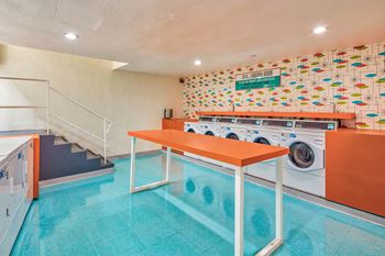 a laundry room with a table and a washing machine  at Rancho Los Feliz, Los Angeles, CA