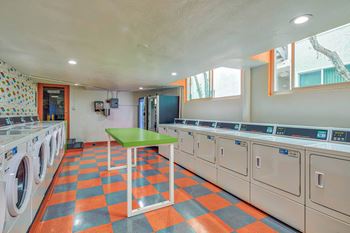 a washer and dryer room with a green table in the middle  at Rancho Los Feliz, California, 90039