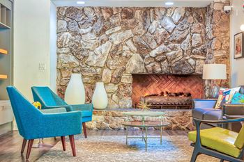 a living room with a stone wall and a fireplace  at Rancho Los Feliz, Los Angeles, CA, 90039