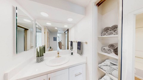 a white bathroom with a sink and a mirror