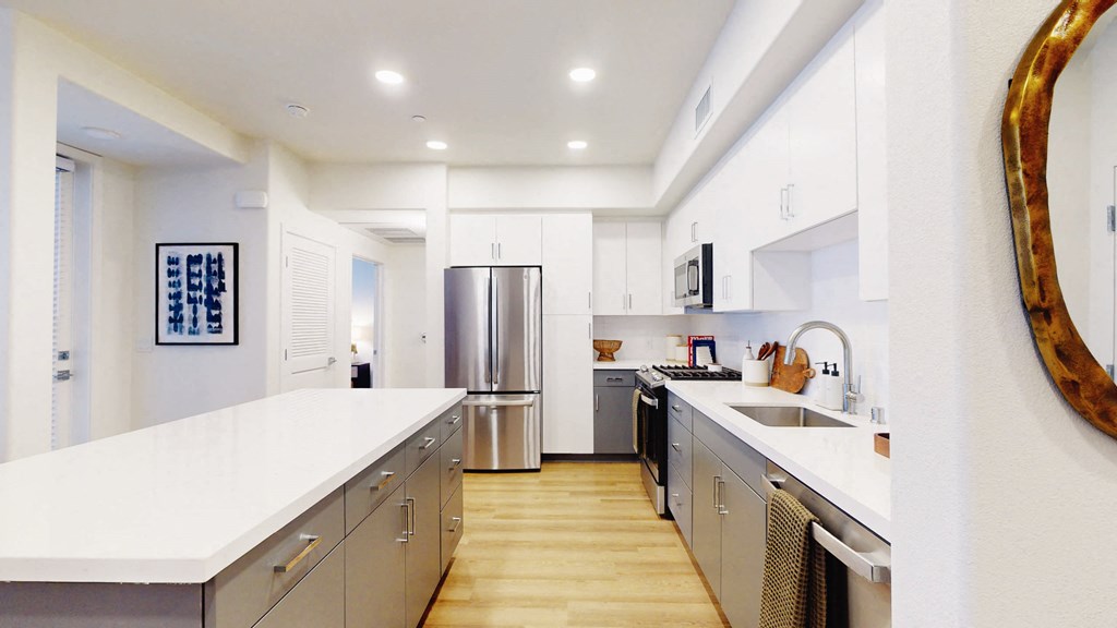 a large kitchen with stainless steel appliances and white counter tops at The Villas at Anacapa Canyon, Camarillo
