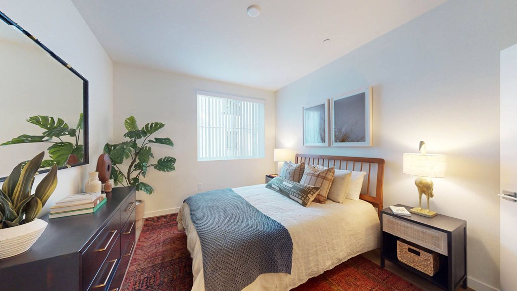a bedroom with a bed and a dresser at The Villas at Anacapa Canyon, Camarillo