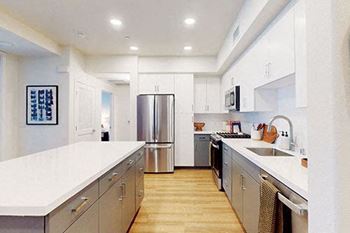 a large kitchen with stainless steel appliances and white counter tops at The Villas at Anacapa Canyon, Camarillo, California