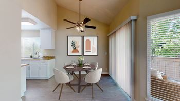 a dining room with a table and chairs and a ceiling fan at Valley Plaza Villages, Pleasanton