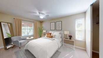 a bedroom with a bed and a chair and a ceiling fan at Valley Plaza Villages, Pleasanton, CA